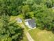 Aerial view of a charming white house surrounded by lush greenery at 16000 W 700 S, Anderson, IN 46017