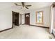 Bedroom featuring a ceiling fan, two entryways, and a window for ample natural light at 16000 W 700 S, Anderson, IN 46017