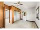 Bedroom with neutral carpet, an open closet, wood paneling, and bright natural light at 16000 W 700 S, Anderson, IN 46017