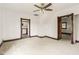 Large bedroom features a ceiling fan, two entryways, and bright neutral carpet at 16000 W 700 S, Anderson, IN 46017