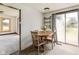 The dining area features a wood table and chairs with backyard views from a glass sliding door at 16000 W 700 S, Anderson, IN 46017
