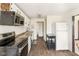 This kitchen features black appliances, white cabinets, and a moveable island at 16000 W 700 S, Anderson, IN 46017