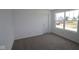 A clean bedroom with a large window overlooking the neighborhood and soft, neutral carpet at 17110 Cowbell Dr, Noblesville, IN 46060