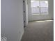 Cozy bedroom with neutral carpet, white walls, and a window with a view of neighboring houses at 17110 Cowbell Dr, Noblesville, IN 46060