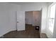 Well-lit room with hardwood floors, white walls, and a view of additional rooms at 17110 Cowbell Dr, Noblesville, IN 46060