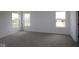 Spacious bedroom with neutral carpet, white walls, and large windows allowing ample sunlight at 17110 Cowbell Dr, Noblesville, IN 46060