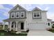 Charming two-story home featuring a covered front porch and a two-car garage at 17110 Cowbell Dr, Noblesville, IN 46060