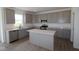 Well-equipped kitchen featuring stainless steel appliances, gray cabinets, and a center island at 17110 Cowbell Dr, Noblesville, IN 46060