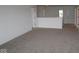 Spacious carpeted room with neutral walls, offering a versatile living space at 17110 Cowbell Dr, Noblesville, IN 46060