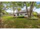 Nice backyard featuring a gray house, green grass, trees, and partial fencing at 19522 Diamond Way, Noblesville, IN 46062