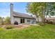 Backyard featuring a gray house, patio, green grass, and a fire pit at 19522 Diamond Way, Noblesville, IN 46062