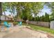 Inviting backyard with stone fire pit area, chairs, trees, and fenced yard at 19522 Diamond Way, Noblesville, IN 46062