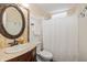 Well-lit bathroom with a decorative mirror, vanity, and shower with curtain at 19522 Diamond Way, Noblesville, IN 46062