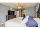 Well-lit bedroom boasts a plush bed, a dresser with a TV, and access to the bathroom at 19522 Diamond Way, Noblesville, IN 46062