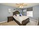 Serene bedroom with a decorative headboard and ceiling fan, complemented by soothing blue walls at 19522 Diamond Way, Noblesville, IN 46062