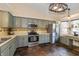 Bright kitchen featuring updated stainless steel appliances, gray cabinetry, and an eat-in breakfast nook at 19522 Diamond Way, Noblesville, IN 46062