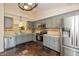 Well-equipped kitchen with stainless steel appliances, gray cabinets, and tiled backsplash at 19522 Diamond Way, Noblesville, IN 46062