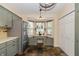 Cozy kitchen showcasing gray cabinets, stainless steel appliances, a breakfast nook, and slate floors at 19522 Diamond Way, Noblesville, IN 46062
