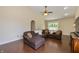 Comfortable living room with a large sectional sofa and ceiling fan with wood-look flooring at 19522 Diamond Way, Noblesville, IN 46062