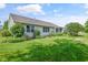 Expansive backyard featuring well-maintained lawn, manicured landscaping, and the home's exterior facade at 2402 Redspire Blvd, Goshen, IN 46526
