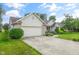 Charming home featuring a two-car garage, brick and siding exterior, and well-manicured front yard at 2402 Redspire Blvd, Goshen, IN 46526
