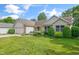 View of the front lawn of a single Gathering home with an attached garage and well maintained landscaping at 2402 Redspire Blvd, Goshen, IN 46526