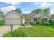 Charming single-story home with a well-manicured lawn, flowerbeds, and attached garage, providing curb appeal at 2402 Redspire Blvd, Goshen, IN 46526