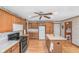View of a well-lit kitchen, featuring wood cabinets, a center island, and modern appliances at 2402 Redspire Blvd, Goshen, IN 46526