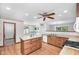Open concept kitchen featuring wood cabinets, a central island, and a seamless flow into the dining area at 2402 Redspire Blvd, Goshen, IN 46526