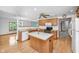 Traditional eat-in kitchen with wood cabinets, an island, and wood floors offering functional space at 2402 Redspire Blvd, Goshen, IN 46526