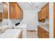 Bright laundry area features modern washer and dryer, ample wood cabinet storage, and sink at 2402 Redspire Blvd, Goshen, IN 46526