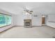 Bright living room with plush carpet, a cozy stone fireplace, and a large window at 2402 Redspire Blvd, Goshen, IN 46526