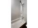 White bathtub with chrome shower head and faucets on light colored wall at 249 N Mill St, Plainfield, IN 46168
