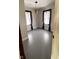 Empty bedroom featuring painted floors and large windows with dark curtains at 249 N Mill St, Plainfield, IN 46168