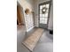 Charming entryway features stylish decor, a hat, and a runner rug, creating a welcoming first impression at 249 N Mill St, Plainfield, IN 46168