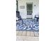 Cozy porch showcasing chairs, a leaf pattern rug, and a door with a wreath on a beautiful home at 249 N Mill St, Plainfield, IN 46168