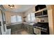 Updated kitchen features stainless steel appliances, ample counter space and custom cabinets at 249 N Mill St, Plainfield, IN 46168