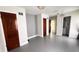 Spacious living room featuring painted floors, shiplap accent wall and warm lighting at 249 N Mill St, Plainfield, IN 46168