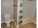 Bathroom view of a toilet and shower with a curtain at 2502 N Harding St, Indianapolis, IN 46208