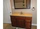 Bathroom featuring vanity with drawers, a mirror, sink, and tan walls at 2502 N Harding St, Indianapolis, IN 46208