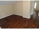 Bedroom featuring dark wood floors and white baseboards at 2502 N Harding St, Indianapolis, IN 46208
