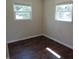 Bedroom featuring neutral walls, hardwood-look floors, and natural light from the windows at 2502 N Harding St, Indianapolis, IN 46208
