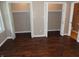 Bedroom with wood-look flooring, ample closet space, and natural light at 2502 N Harding St, Indianapolis, IN 46208