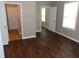 Bedroom with rich hardwood flooring, neutral colored walls, and multiple windows at 2502 N Harding St, Indianapolis, IN 46208