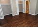 This bedroom with ensuite bathroom and closet features wood-look floors and neutral walls at 2502 N Harding St, Indianapolis, IN 46208