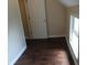 Bedroom featuring dark wood floors, white baseboards, a window, and a closet at 2502 N Harding St, Indianapolis, IN 46208