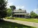 Charming home with inviting porch and well-maintained landscaping on a sunny day at 2502 N Harding St, Indianapolis, IN 46208