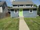 Charming home with a freshly painted exterior and a bright green front door at 2502 N Harding St, Indianapolis, IN 46208