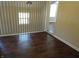 Hallway with wood floors, staircase, and a window at 2502 N Harding St, Indianapolis, IN 46208