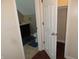 Hallway between a bathroom and closet featuring dark wood floors at 2502 N Harding St, Indianapolis, IN 46208